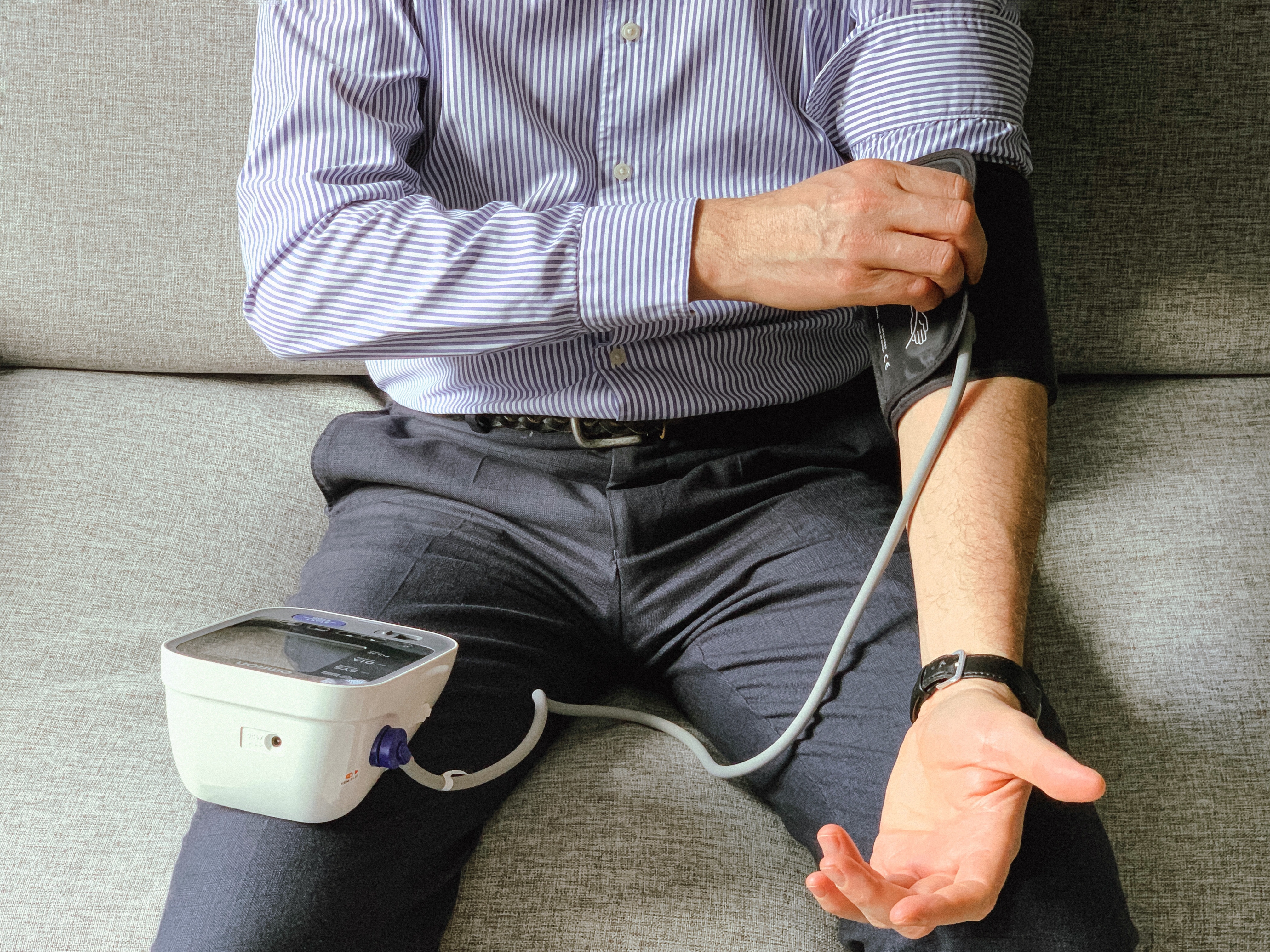 man-checking-blood-pressure-at-home-sitting-on-so-2024-12-07-21-07-44-utc.jpg